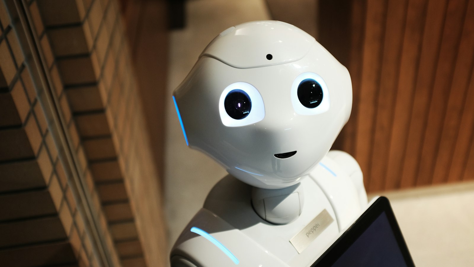 Humanoid robot hand reaching toward a human hand
