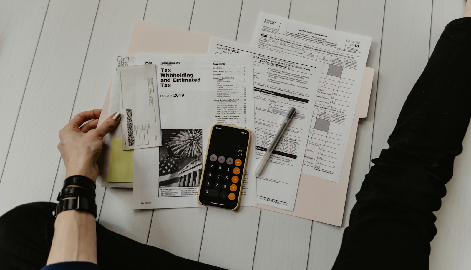 Calculator and documents on a desk during a payment review