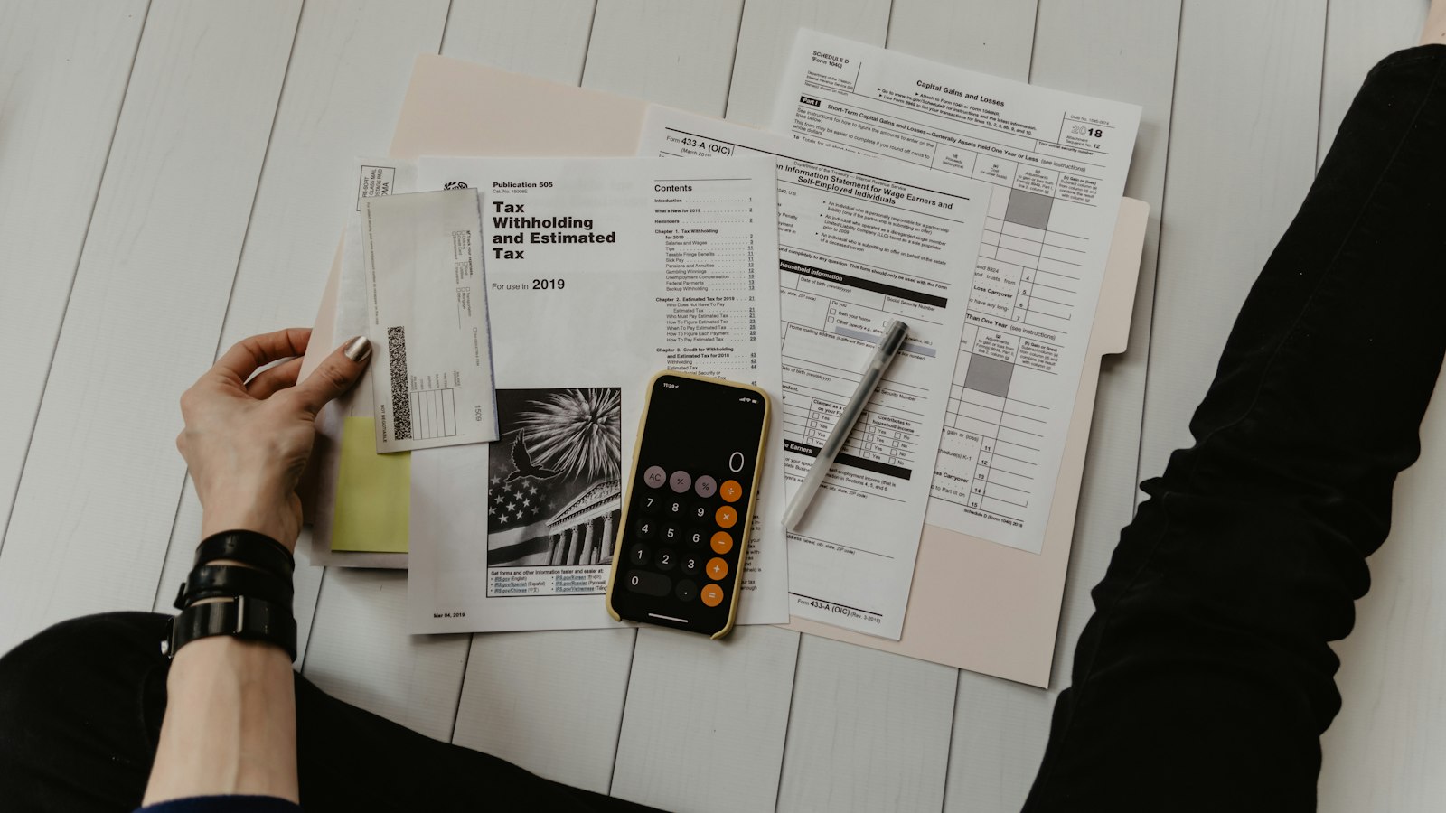 Desk with calculator, invoices, and financial documents